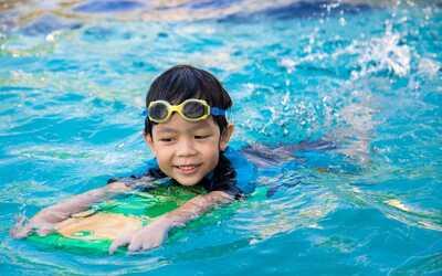 A kid swimming in a clean pool